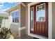 Close up of home's front door showing a decorative door with sidelights at 3139 Hurston Watch Ln, Clermont, FL 34711