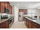 A kitchen showcasing granite countertops, stainless steel appliances, and modern cabinetry at 3139 Hurston Watch Ln, Clermont, FL 34711