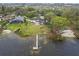 Aerial view of the property, showcasing its lake access and surrounding homes at 31400 Saunders Dr, Tavares, FL 32778