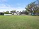 Large, well-maintained backyard featuring a sunroom and screened-in pool at 31400 Saunders Dr, Tavares, FL 32778