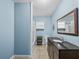 Bright bathroom features a modern vanity with a dark countertop, a mirror, toilet, and shower at 31400 Saunders Dr, Tavares, FL 32778