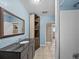 Stylish bathroom features a modern vanity with a dark countertop, a mirror, and tiled floors at 31400 Saunders Dr, Tavares, FL 32778