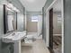 Bathroom with a pedestal sink and tiled shower at 31400 Saunders Dr, Tavares, FL 32778