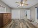 Bedroom with wood-look floors, closet and dresser at 31400 Saunders Dr, Tavares, FL 32778