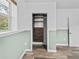 Bedroom featuring wood look floors, trim accent, large window, and a closet with built in shelving at 31400 Saunders Dr, Tavares, FL 32778