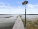 View of the wooden dock leading into the lake at 31400 Saunders Dr, Tavares, FL 32778