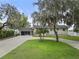 Charming single-story home with brick exterior, front porch, and a spacious circular driveway at 31400 Saunders Dr, Tavares, FL 32778