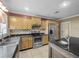 Well-lit kitchen featuring stainless steel appliances, granite countertops, and light wood cabinetry at 31400 Saunders Dr, Tavares, FL 32778