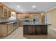 Well-equipped kitchen with wooden cabinets, stainless steel appliances, and a central island at 31400 Saunders Dr, Tavares, FL 32778