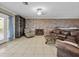 Comfortable living room with tile floors, a brick accent wall, a fireplace and a dark wood bookshelf at 31400 Saunders Dr, Tavares, FL 32778