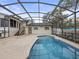 Backyard shot of the screened-in pool with an attached guest house at 31400 Saunders Dr, Tavares, FL 32778