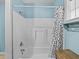 A shower featuring a white showerhead, white fixtures, and a black and white shower curtain at 31400 Saunders Dr, Tavares, FL 32778