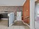 Stairway with brick accent wall leading from interior to the outside at 31400 Saunders Dr, Tavares, FL 32778