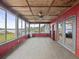 Cozy sunroom with brick accent walls, tile floors, and exterior views at 31400 Saunders Dr, Tavares, FL 32778