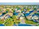Aerial view of a well-maintained home with lush landscaping and mature palm trees at 3144 Mayflower Loop, The Villages, FL 32163