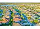 Aerial view of neighborhood featuring mature trees, manicured lawns, and a lake at 3144 Mayflower Loop, The Villages, FL 32163