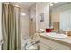 Well-lit bathroom featuring a shower and tub combination with grab bars, a sink, and toilet at 3144 Mayflower Loop, The Villages, FL 32163