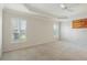 Spacious bedroom with tray ceilings and two shuttered windows offering ample natural light at 3144 Mayflower Loop, The Villages, FL 32163