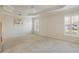 Large bedroom with tray ceilings and two windows with shutters, offering a lot of natural light at 3144 Mayflower Loop, The Villages, FL 32163