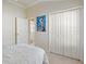 Comfortable bedroom features closet and adjacent bathroom at 3144 Mayflower Loop, The Villages, FL 32163