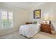 Cozy bedroom with natural lighting, complemented by light neutral walls and framed art at 3144 Mayflower Loop, The Villages, FL 32163