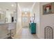 Inviting foyer featuring tile flooring, a decorative cabinet, leading to a kitchen area, and a front door at 3144 Mayflower Loop, The Villages, FL 32163