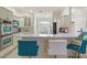 Bright kitchen featuring white cabinetry, modern stainless steel appliances, and a breakfast bar with stylish seating at 3144 Mayflower Loop, The Villages, FL 32163
