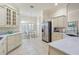 Spacious kitchen featuring ample cream cabinetry, granite countertops, stainless steel appliances, and breakfast nook at 3144 Mayflower Loop, The Villages, FL 32163