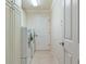 Laundry room with modern white washer and dryer and ample storage at 3144 Mayflower Loop, The Villages, FL 32163