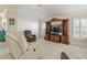 Bright living room featuring a ceiling fan and built-in entertainment center with lots of natural light at 3144 Mayflower Loop, The Villages, FL 32163