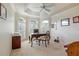 Office space featuring coffered ceilings, three windows with shutters, and a decorative wooden desk at 3144 Mayflower Loop, The Villages, FL 32163