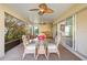 Inviting screened-in patio with a glass table, wicker chairs and views of outdoor foliage at 3144 Mayflower Loop, The Villages, FL 32163