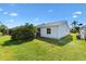 Spacious backyard with lush green grass and manicured landscaping at 3349 Ashbrook Pl, The Villages, FL 32162