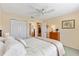 Comfortable bedroom featuring neutral colors, a ceiling fan, closet space, and a pleasant view into the hallway at 3349 Ashbrook Pl, The Villages, FL 32162