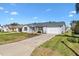 Charming single-story home with manicured lawn and driveway leading to an attached two-car garage at 3349 Ashbrook Pl, The Villages, FL 32162