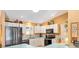 Kitchen features modern appliances, white cabinets, and light countertops at 3349 Ashbrook Pl, The Villages, FL 32162