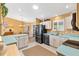 Bright kitchen featuring white cabinets, light countertops, modern appliances, and a convenient layout at 3349 Ashbrook Pl, The Villages, FL 32162