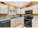 Bright kitchen featuring white cabinets, stainless steel appliances, and a double sink at 3349 Ashbrook Pl, The Villages, FL 32162