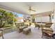 Enclosed lanai featuring comfortable seating and views of the landscaped yard at 3349 Ashbrook Pl, The Villages, FL 32162