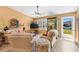 Cozy living room with comfortable seating, neutral colors, and natural light streaming through the windows and door at 3349 Ashbrook Pl, The Villages, FL 32162