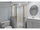 Modern bathroom featuring a glass-enclosed shower, toilet, and vanity, designed for comfort and functionality at 3430 Turningwind Ln, Winter Garden, FL 34787
