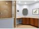 Bathroom featuring a walk-in shower with glass door and vanity with drawers at 3430 Turningwind Ln, Winter Garden, FL 34787