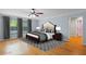 Staged bedroom featuring wood floors, a ceiling fan, and neutral decor at 3430 Turningwind Ln, Winter Garden, FL 34787