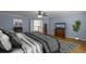 Serene bedroom with wood floors, modern furnishings, and ample natural light at 3430 Turningwind Ln, Winter Garden, FL 34787