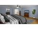 Comfortable bedroom with wood floors, neutral decor, and ample space for relaxation at 3430 Turningwind Ln, Winter Garden, FL 34787