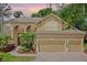 Charming two-story home featuring a three-car garage, manicured landscaping, and a welcoming entrance at 3430 Turningwind Ln, Winter Garden, FL 34787
