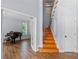 Inviting foyer with wood floors, a staircase, and a view of a room with a piano at 3430 Turningwind Ln, Winter Garden, FL 34787