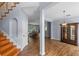 Spacious foyer with hardwood floors, stairs, and a view into the living room and dining area at 3430 Turningwind Ln, Winter Garden, FL 34787