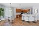 Bright kitchen with stainless steel appliances, wood cabinetry, and breakfast bar with seating at 3430 Turningwind Ln, Winter Garden, FL 34787
