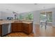Bright kitchen area with modern appliances, wooden cabinets, and an eat-in kitchen nook at 3430 Turningwind Ln, Winter Garden, FL 34787